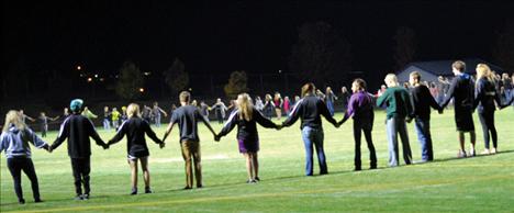 Berl Tiskus/Valley Journal Participants stand on the Polson High School football field for the ending prayer. Then kids joined student Fields of Faith leaders who passed out devotional books.
