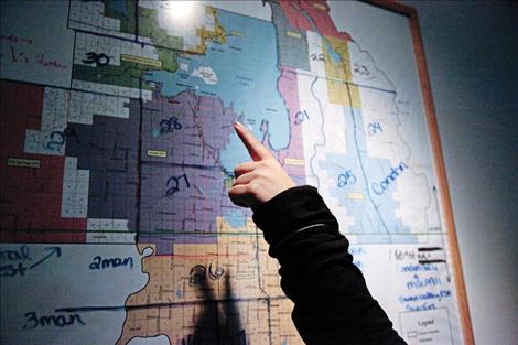 A Lake County dispatcher points out county lines and areas covered by dispatch.