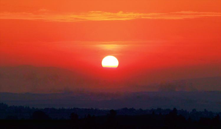 At the end of a fall day, just before the sun dips out of sight, it sweeps the sky with vibrant hues of red and orange.