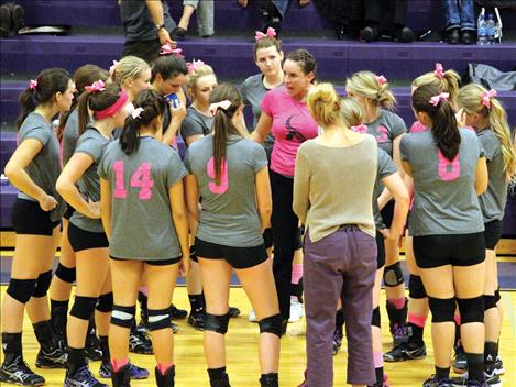 Wearing pink in honor of breast cancer awareness, Coach Jan Toth discusses a plan of attack with the Lady Pirates.