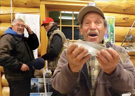 Felix Gauci reacts when he discovers the small lake trout in his hands is the one and only tagged fish worth $10,000 in the Fall Mack Days fishing contest.