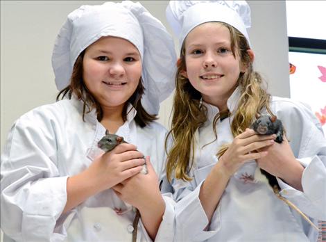 Maysa Couture,10, and Ahni Umphrey, 10, dressed up as the chef from the movie Ratatouille with their pet rats. 