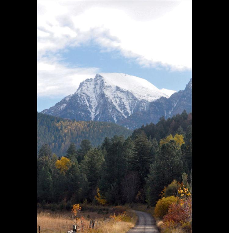 Falling autumn leaves and snowcapped mountains show their hues in St. Ignatius.