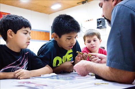 Bob Cornwell of Ronan Telephone Company teaches boys about his job during Career Day. 