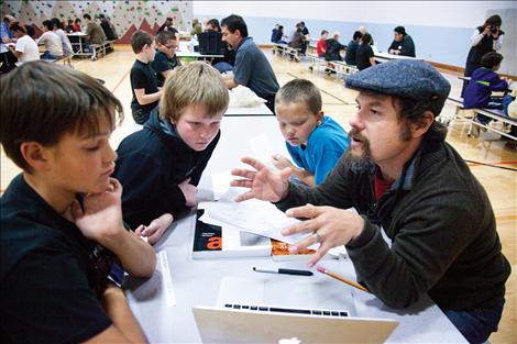 Mike Lozar works with kids at Ronan Career Days. 