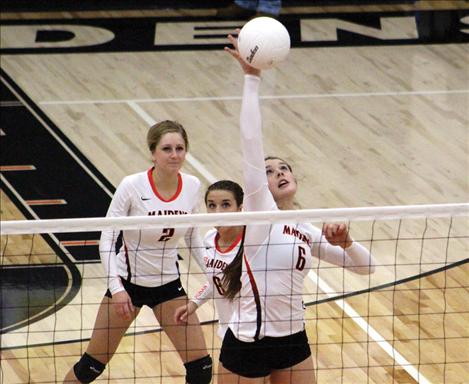 Maiden Kendra Starkel slams the ball over the net in a Divisonal match against Plains.