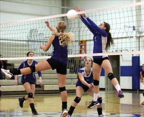 Lady Bulldog Lindsay Johnson blocks a kill from Lady Viking Mikaylan Roylance.