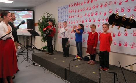 Students at Glacier View Christian School sing the national anthem at their program for veterans.