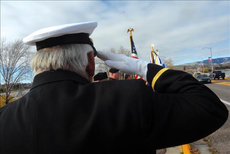 Members of the American Legion, Post 112 in Polson stand at attention along the Armed Forces Memorial Bridge in Polson at 11 a.m. on Nov. 11.