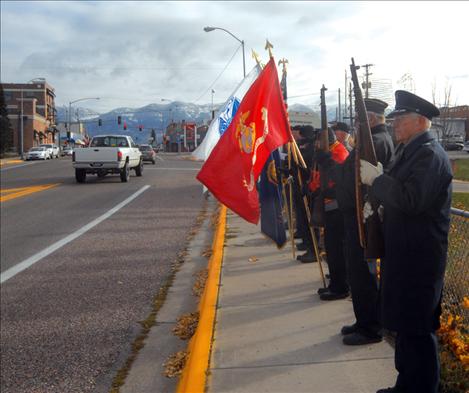 Members of the American Legion, Post 112 in Polson stand at attention along the Armed Forces Memorial Bridge in Polson at 11 a.m. on Nov. 11.