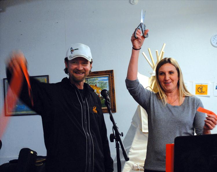 Jason Moore, left, head of Montana Co-op and the Kids' Co-op and Polson Mayor Heather Knutson cut the ribbon officially opening the co-ops on Nov. 14