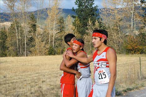 From left to right, Donovan McDonald, Isaac Desjarlais and Al Plant embrace after the 3.2 mile run.