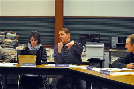 Superintendent Thom Peck excitedly tells school board trustees the 