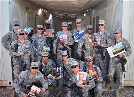 Soldiers who have received books, magazines and DVDs through Magazine for Troops pose for photo to accompany a thank you note for  lifting their spirits.