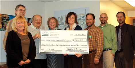Members of Lake County Community Development Corporation accept USDA funding Nov. 19 from Anthony J. Preite, Montana state director, USDA Rural Development. Pictured above, from left, are Carol Cunningham, client services manager; Steve Dagger, LCCDC board vice president; Anthony J. Preite; Billie Lee, director of special programs; Gypsy Ray, executive director; John Winegart, loan portfolio manager; Brennin Grainey, board president; Paul Soukup, board secretary and treasurer.