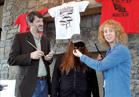 Mindy “Duck Dynasty” Corrigan’s “facial hair” earns her the Mo’ It Girl Award at Black Mountain Software’s Movember Challenge to raise awareness of men’s health issues. Dr. John Williams of St. Luke Community Health Care, left, and Shauna Rubel of Glacier Bank, right, serve as guest judges.