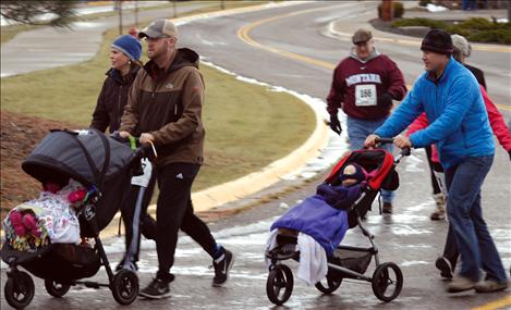 The stroller brigade with warmly wrapped kids begins the 3-mile Turkey Trot. 