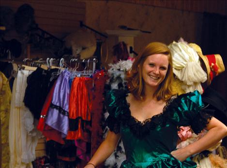 Tasha Avison stands in front of a rack of costumes for the Old Time Photo Shop.