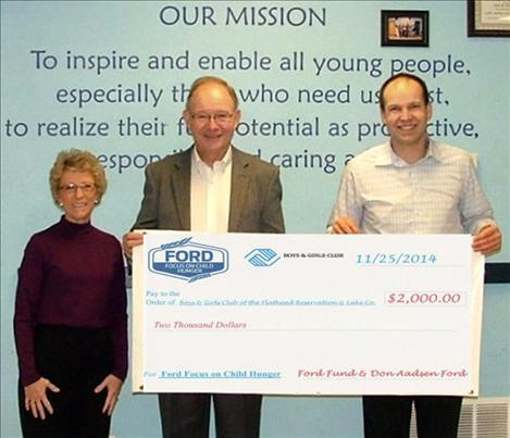 ric Cooksley, right, executive director of the Boys and Girls Club of the Flathead Reservation and Lake County, accepts a $2,600 check from the Ford Fund and Ann and Gordon Henricksen of Don Aadsen Ford.