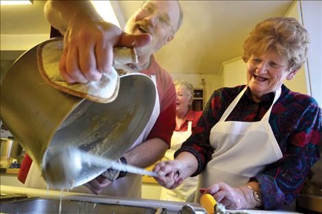Scott Heinz refills the gravy tray so Jo Durand, background, and Kaye Stamm, right, can keep the plates full.