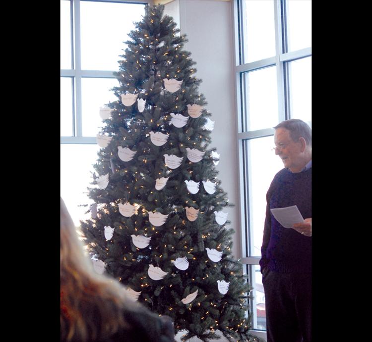 Reverend John Payne leads a prayer at the candlelight Tree of Lights ceremony held at Providence St. Joseph’s Medical Center.