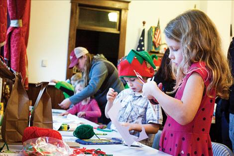 Children create Grinch crafts.