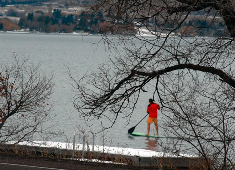 Berl Tiskus/Valley Journal A very brave and solo paddleboarder makes his way along the snowy, frigid waters of Flathead Lake.