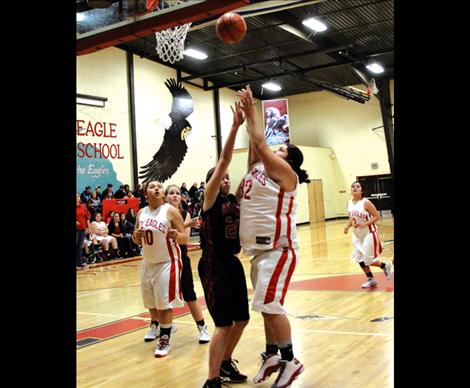 Lady Eagle Tyra Michel jumps above Hot Springs defense to score.