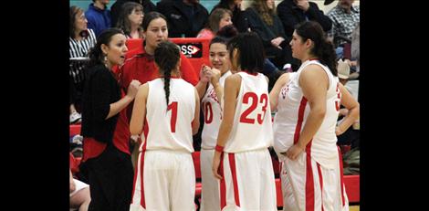 Lady Eagle Coach Erica Shelby offers fist bumping encouragment to her team between quarters.