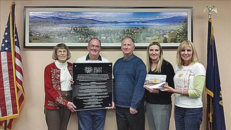Heart and Soul project members Penny Jarecki, Daniel Smith, and Darlis Smith (right), present Polson City Manager Mark Shrives and Polson City Mayor Heather Knutson (center) with a plaque to the city for its help with the community Heart and Soul project.