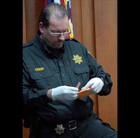 A Lake County Sheriff Deputy shows the knife that was used in the  stabbing death of John Pierre Jr. to jury members.