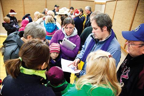 Members of the Church of Latter-Day Saints work to gather and distribute items from a food and clothing drive. 