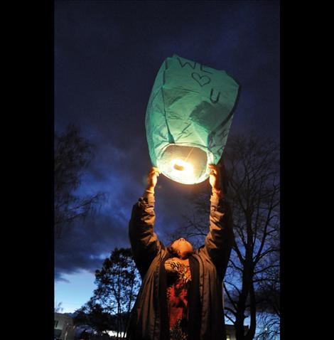 Adria Green lights a sky lantern in front of Lake County Courthouse as family members watch on, in remembrance of her brother, John Pierre, Jr. who was stabbed to death by Makueeyapee Whitford in March 2013. 