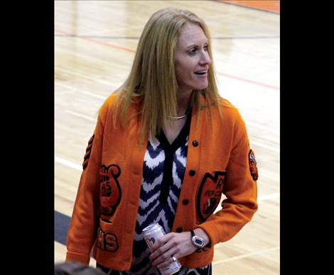 Wearing a sweater from the ‘70s, Ronan Athletic Director Courtney Fisher organized the throwback game to attract former athletes and students to attend more high school events.