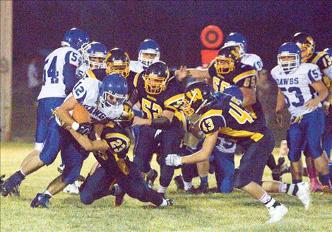 Ryce Hegwood is attacked by Wardens as he carries the ball for Mission.