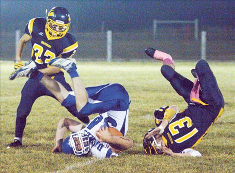 Will Powell takes a tumble after being tackled by Deer Lodge’s Tristen Clark.