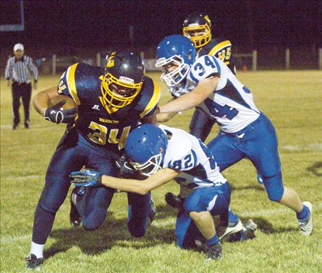 Bulldogs Jarred Brown and Will Powell take down Deer Lodge’s Trevor Cuchine Friday night.