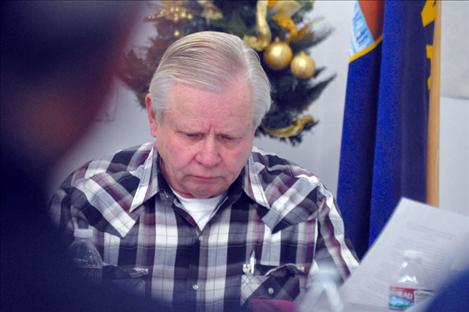 Flathead Joint Board of Control Board Member Ted Hein ponders edits to a proposed resolution regarding the CSKT Water Compact.