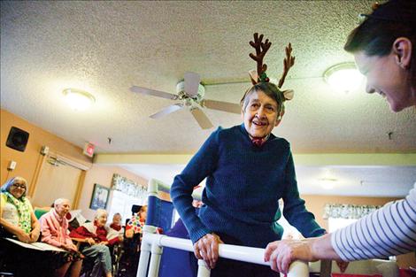 A resident reindeer pulls the sleigh with her walker;