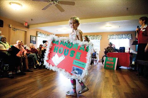 Young Shelby Weiss notes a change of scene from The North Pole to Grandma’s House.