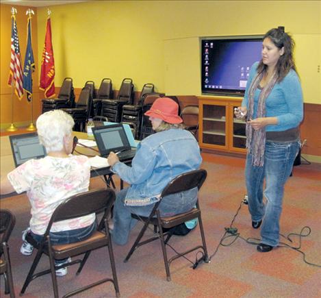 Technology training specialist Mandy Moran, right, teaches a free computer class to interested students at North Lake County Public Library.