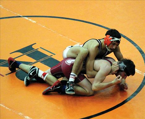 Chief Jared Neiss uses grappling moves to lock a Hamilton-Victor opponent up on the mat. Neiss won six matches at the Western Montana Duals Tournament.