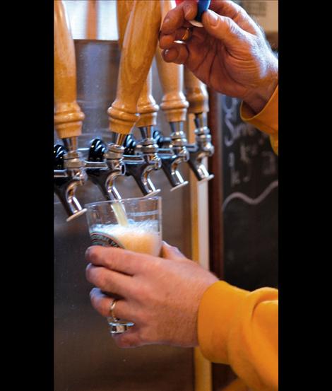 Dave Ayers pours Glacier Brewery beer from the tap. “Here it is — love in a glass,” Ayers said.
