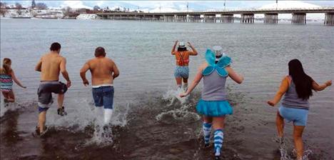 People wore hats, tutus and even wings over their swimsuits as they jumped into Flathead Lake. 