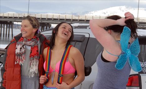 Connie Bull, left, Monica Cleveland and Jamie Olson recover after they started the New Year out with a plunge into chilly Flathead Lake. It was cold enough that Bull’s pigtails froze.