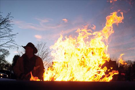 Bill Smith mans the bonfire where folks gathered to light lanterns.