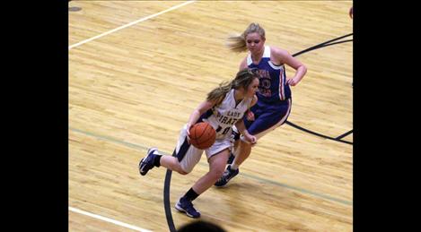 Senior Skyla Krantz darts around Wildkats. Krantz leads the conference in steals.