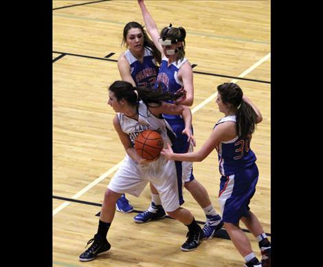 Lady Pirate Nichole Lake works her way around Columbia Falls defense in Saturday’s game. Lake is leading the conference in rebounds and points per games played.