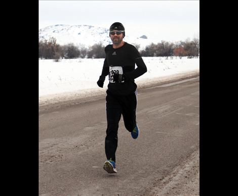 Jason Delaney crossed the finish line first in the 13.1 mile run at 1:26:28.