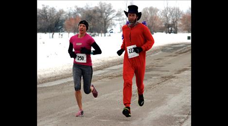 Trisha Drobeck and Matt Seeley pace each other in the chilly morning race to take second and third overall.
